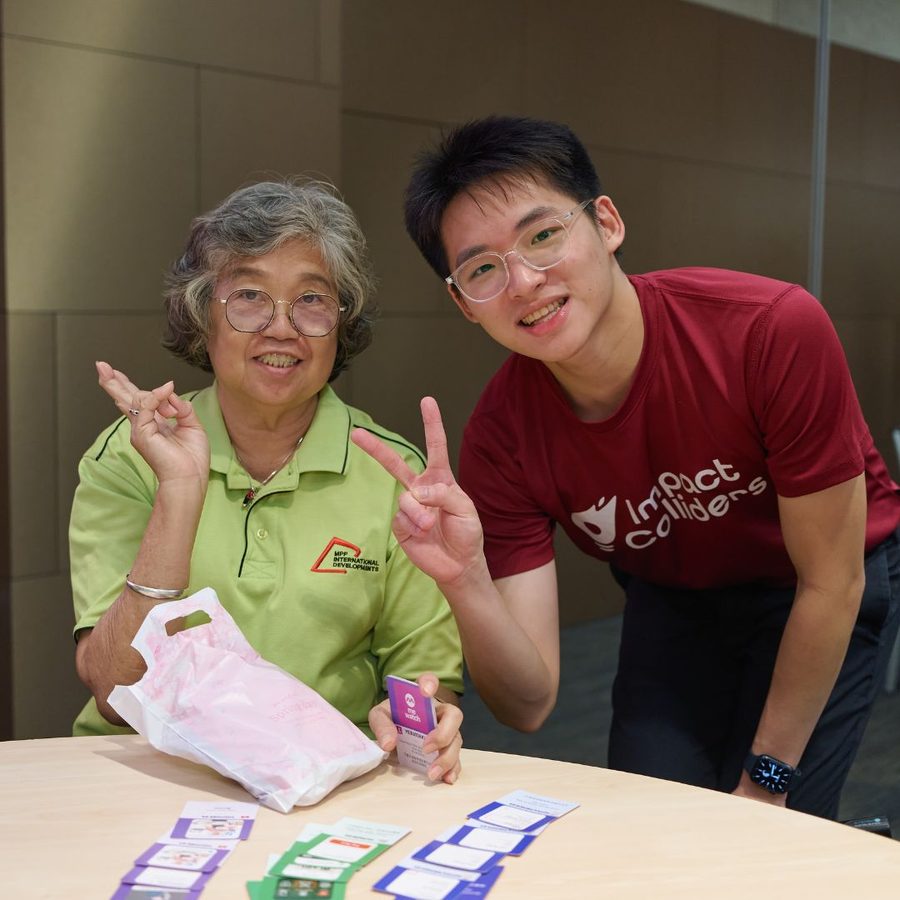 Volunteer and senior playing Eh, How Ah? together