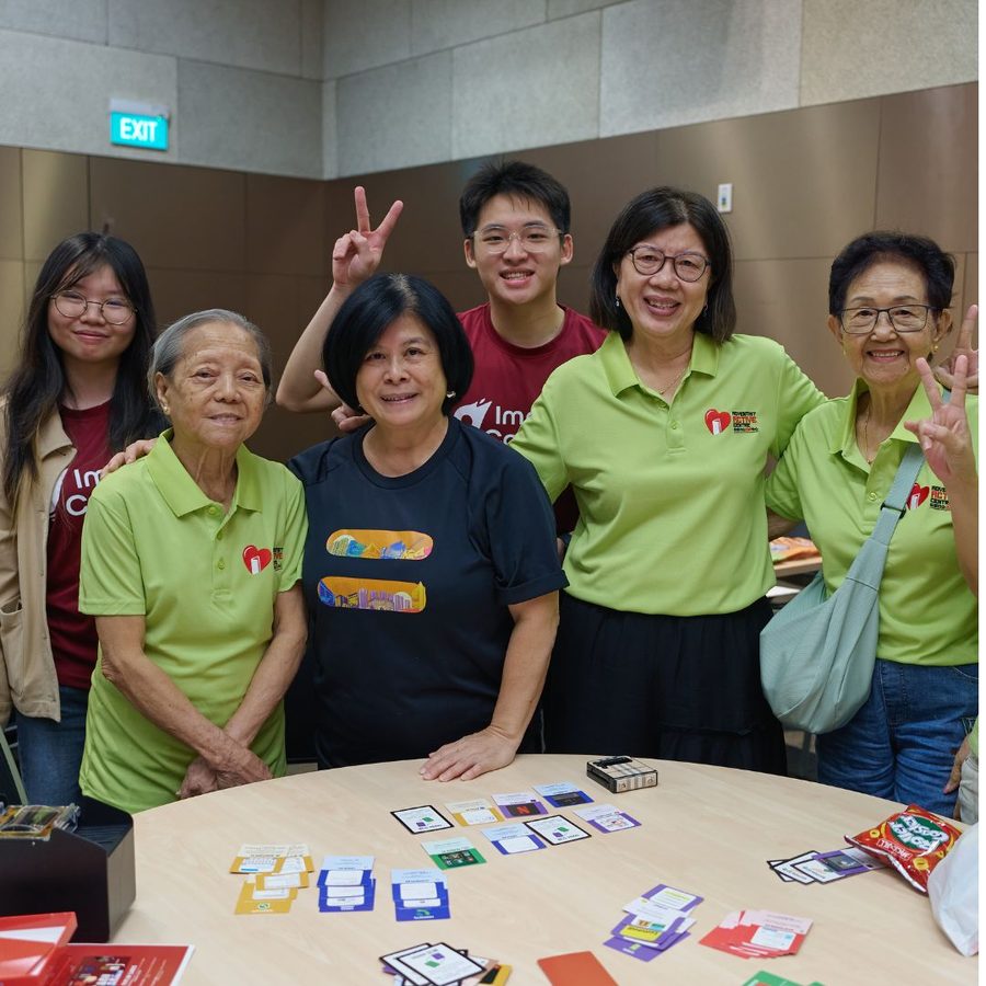 Volunteers and seniors with the Eh, How Ah? card game