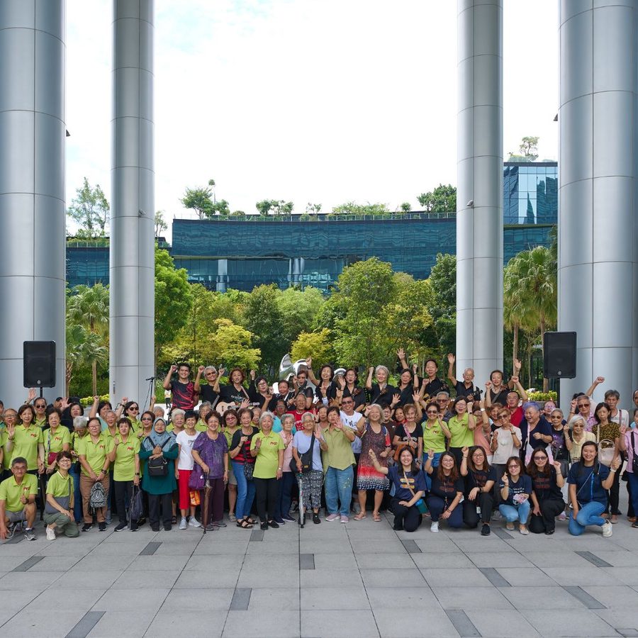 Seniors and volunteers posing together outdoors