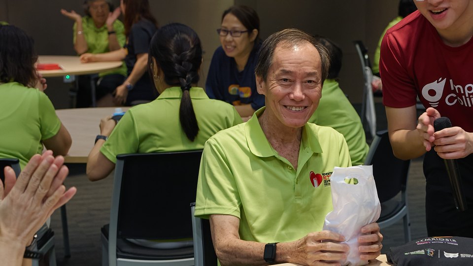 Participant holding a prize after sharing his story